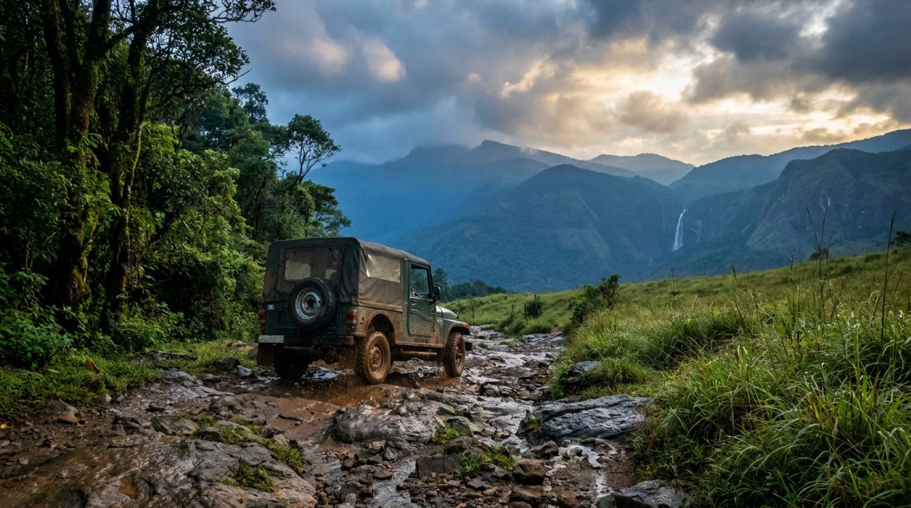 Off-road jeep climbing a rocky trail through forest and grassland in the Western Ghats of Kerala
