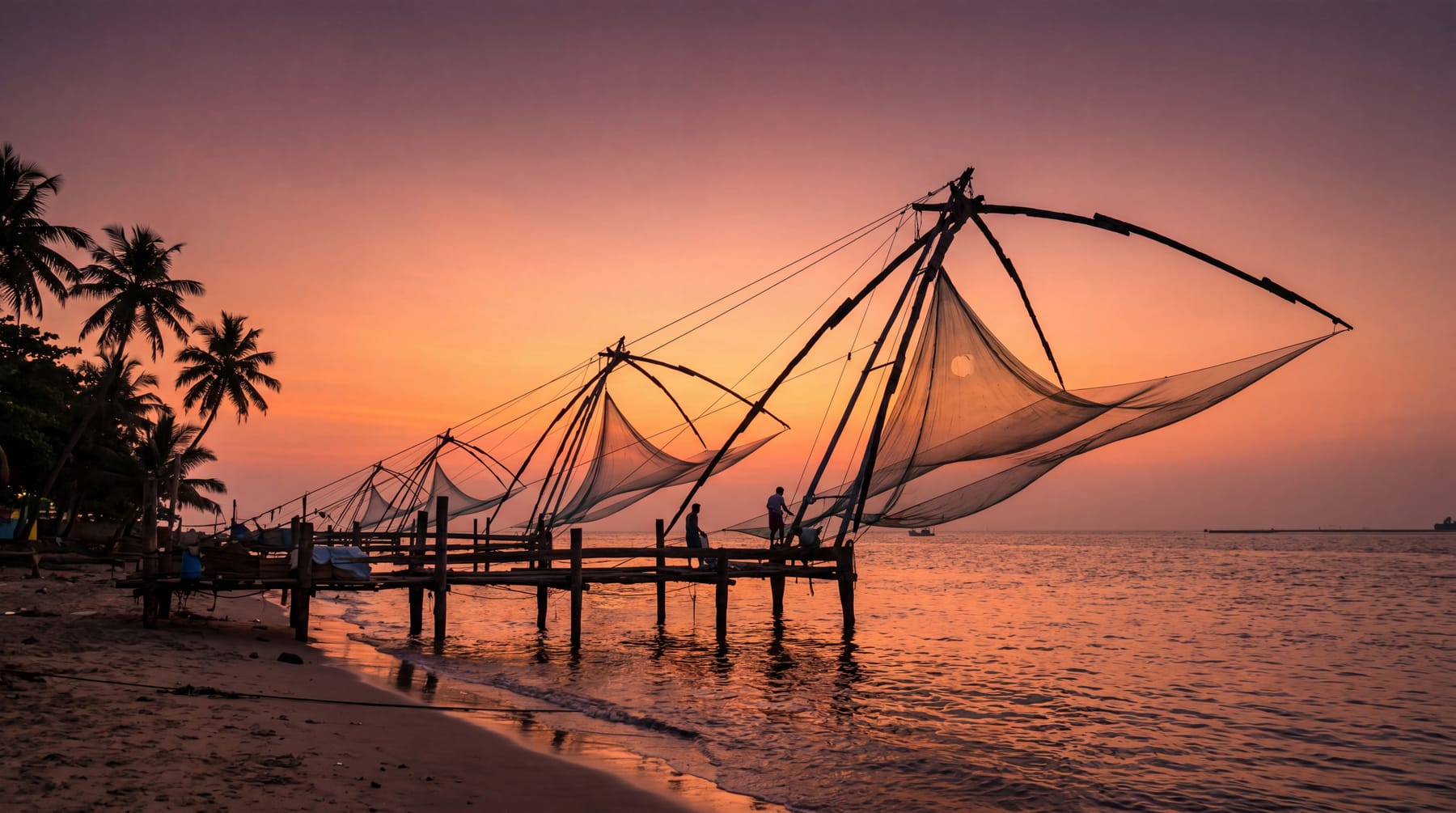 The iconic Chinese fishing nets silhouetted at sunset in Fort Kochi, Kerala