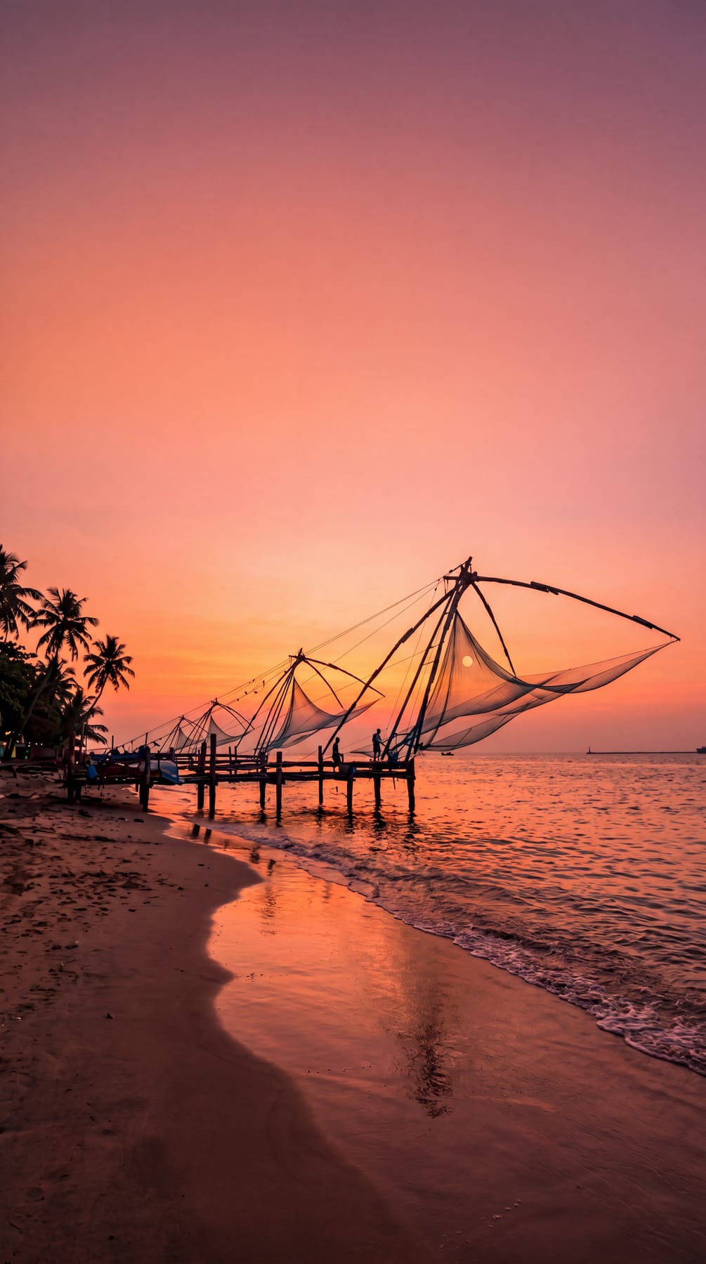 The iconic Chinese fishing nets silhouetted at sunset in Fort Kochi, Kerala